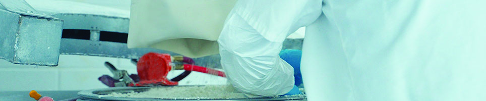 A person holding a tablet with holographic circles floating from it. 