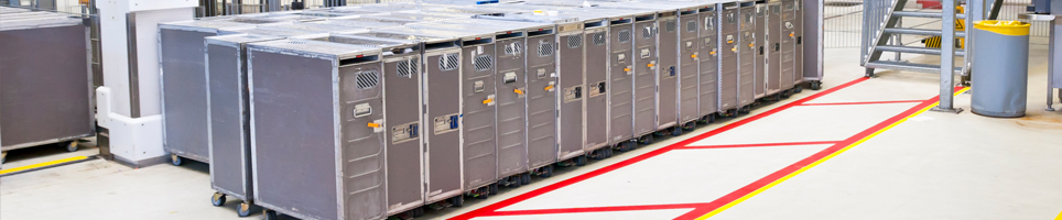 A lab filled with metal holding containers.