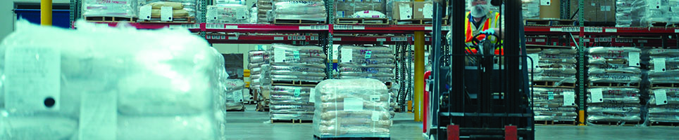 Two men in white coats and hairnets shaking hands